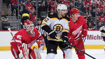 DETROIT, MI - FEBRUARY 09: Goaltender Jonathan Bernier #45 of the Detroit Red Wings is screened as teammate Gustav Lindstrom #28 battles for position with Sean Kuraly #52 of the Boston Bruins during an NHL game at Little Caesars Arena on February 9, 2020 in Detroit, Michigan. (Photo by Dave Reginek/NHLI via Getty Images)