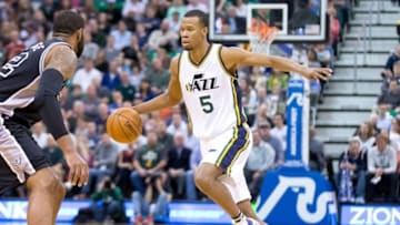 Apr 5, 2016; Salt Lake City, UT, USA; Utah Jazz guard Rodney Hood (5) dribbles the ball as San Antonio Spurs forward LaMarcus Aldridge (12) moves to defend during the first half at Vivint Smart Home Arena. Mandatory Credit: Russ Isabella-USA TODAY Sports