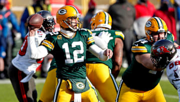 Jan 24, 2021; Green Bay, Wisconsin, USA; Green Bay Packers quarterback Aaron Rodgers (12) throws a pass during the first quarter against the Tampa Bay Buccaneers in the NFC Championship Game at Lambeau Field. Mandatory Credit: Jeff Hanisch-USA TODAY Sports