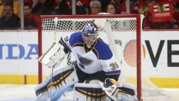 Apr 23, 2014; Chicago, IL, USA; St. Louis Blues goalie Ryan Miller (39) covers the puck against the Chicago Blackhawks during the second period in game four of the first round of the 2014 Stanley Cup Playoffs at United Center. Mandatory Credit: Jerry Lai-USA TODAY Sports