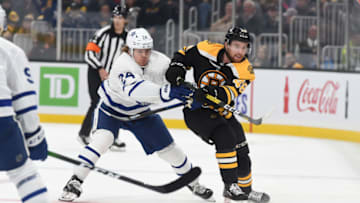 BOSTON, MA - OCTOBER 22: Matt Grzelcyk #48 of the Boston Bruins passes the puck against Kasperi Kapanen #24 of the Toronto Maple Leafs at the TD Garden on October 22, 2019 in Boston, Massachusetts. (Photo by Steve Babineau/NHLI via Getty Images)