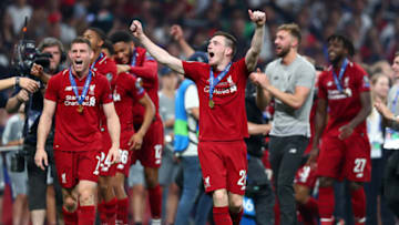 MADRID, SPAIN - JUNE 01: James Milner and Andy Robertson of Liverpool celebrate wearing their winners medals following the UEFA Champions League Final between Tottenham Hotspur and Liverpool at Estadio Wanda Metropolitano on June 01, 2019 in Madrid, Spain. (Photo by Clive Rose/Getty Images)
