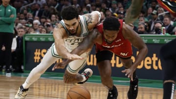 Jayson Tatum #0 of the Boston Celtics and Haywood Highsmith #24 of the Miami Heat battle for a loose ball(Photo By Winslow Townson/Getty Images)