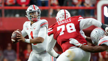 LINCOLN, NE - SEPTEMBER 28: Quarterback Justin Fields #1 of the Ohio State Buckeyes passes ahead of the rush from defensive lineman Darrion Daniels #79 of the Nebraska Cornhuskers at Memorial Stadium on September 28, 2019 in Lincoln, Nebraska. (Photo by Steven Branscombe/Getty Images)