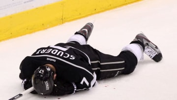 LOS ANGELES, CA - JUNE 11: Rob Scuderi #7 of the Los Angeles Kings lays on the ice after being boarded by Steve Bernier #18 of the New Jersey Devils (not in photo) in Game Six of the 2012 Stanley Cup Final at Staples Center on June 11, 2012 in Los Angeles, California. (Photo by Christian Petersen/Getty Images)