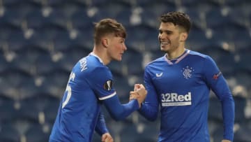 Rangers' Scottish defender Nathan Patterson (L) celebrates with Rangers' Romanian midfielder Ianis Hagi (R) after scoring their second goal during the UEFA Europa League Round of 32, 2nd leg football match between Rangers and Royal Antwerp at the Ibrox Stadium in Glasgow on February 25, 2021. (Photo by RUSSELL CHEYNE / POOL / AFP) (Photo by RUSSELL CHEYNE/POOL/AFP via Getty Images)