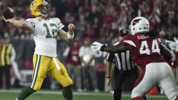 January 16, 2016; Glendale, AZ, USA; Green Bay Packers quarterback Aaron Rodgers (12) throws under pressure against Arizona Cardinals outside linebacker Markus Golden (44) during the first half in a NFC Divisional round playoff game at University of Phoenix Stadium. Mandatory Credit: Kyle Terada-USA TODAY Sports