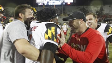 Sep 17, 2016; Orlando, FL, USA; Maryland Terrapins strength coach Rick Court (R) congratulates quarterback Tyrrell Pigrome (C) after scoring during the second half of at Bright House Networks Stadium.Maryland won 30-24. Mandatory Credit: Reinhold Matay-USA TODAY Sports