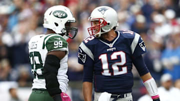 Oct 25, 2015; Foxborough, MA, USA; New England Patriots quarterback Tom Brady (12) speaks to New York Jets outside linebacker Quinton Coples (98) during the first half at Gillette Stadium. Mandatory Credit: Mark L. Baer-USA TODAY Sports