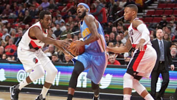Oct 16, 2016; Portland, OR, USA; Denver Nuggets forward Will Barton (5) drives to the basket past Portland Trail Blazers forward Al-Farouq Aminu (8) and guard Damian Lillard (0) during the first quarter at the Moda Center. Mandatory Credit: Craig Mitchelldyer-USA TODAY Sports