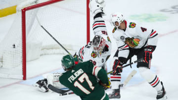 Jan 22, 2022; Saint Paul, Minnesota, USA; Minnesota Wild left wing Marcus Foligno (17) scores a goal against Chicago Blackhawks goaltender Kevin Lankinen (32) in overtime at Xcel Energy Center. Mandatory Credit: David Berding-USA TODAY Sports