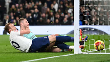 Tottenham Hotspur's English striker Harry Kane scores a goal next to Brighton's English defender Adam Webster during the FA Cup third round football match between Tottenham Hotspur and Brighton and Hove Albion at the Tottenham Hotspur Stadium in London, on February 5, 2022. - - RESTRICTED TO EDITORIAL USE. No use with unauthorized audio, video, data, fixture lists, club/league logos or 'live' services. Online in-match use limited to 120 images. An additional 40 images may be used in extra time. No video emulation. Social media in-match use limited to 120 images. An additional 40 images may be used in extra time. No use in betting publications, games or single club/league/player publications. (Photo by Daniel LEAL / AFP) / RESTRICTED TO EDITORIAL USE. No use with unauthorized audio, video, data, fixture lists, club/league logos or 'live' services. Online in-match use limited to 120 images. An additional 40 images may be used in extra time. No video emulation. Social media in-match use limited to 120 images. An additional 40 images may be used in extra time. No use in betting publications, games or single club/league/player publications. / RESTRICTED TO EDITORIAL USE. No use with unauthorized audio, video, data, fixture lists, club/league logos or 'live' services. Online in-match use limited to 120 images. An additional 40 images may be used in extra time. No video emulation. Social media in-match use limited to 120 images. An additional 40 images may be used in extra time. No use in betting publications, games or single club/league/player publications. (Photo by DANIEL LEAL/AFP via Getty Images)