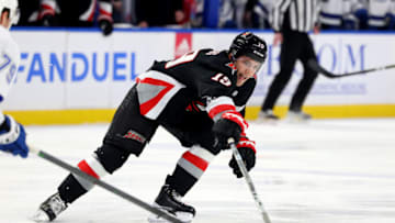Mar 4, 2023; Buffalo, New York, USA; Buffalo Sabres center Peyton Krebs (19) reaches for the puck during the second period against the Tampa Bay Lightning at KeyBank Center. Mandatory Credit: Timothy T. Ludwig-USA TODAY Sports