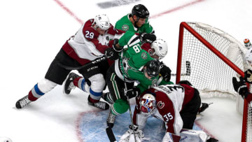 EDMONTON, ALBERTA - SEPTEMBER 02: Michael Hutchinson #35 of the Colorado Avalanche stops a shot against Jason Dickinson #18 and Corey Perry #10 of the Dallas Stars during the second period in Game Six of the Western Conference Second Round during the 2020 NHL Stanley Cup Playoffs at Rogers Place on September 02, 2020 in Edmonton, Alberta, Canada. (Photo by Bruce Bennett/Getty Images)