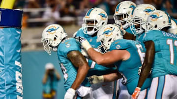 Aug 25, 2016; Orlando, FL, USA; Miami Dolphins running back Arian Foster (left) celebrates his touchdown with teammates during the first half against the Atlanta Falcons at Camping World Stadium. Mandatory Credit: Steve Mitchell-USA TODAY Sports