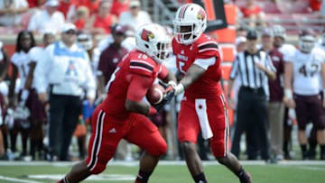 Sep 7, 2013; Louisville, KY, USA; Louisville Cardinals quarterback Teddy Bridgewater (5) hands the ball off to running back Michael Dyer (26) during the second half against Eastern Kentucky Colonels at Papa John