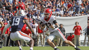 Auburn footballOct 9, 2021; Auburn, Alabama, USA; Georgia Bulldogs quarterback Stetson Bennett (13) carries as Auburn Tigers safety Bydarrius Knighten (19) closes in during the second quarter at Jordan-Hare Stadium. Mandatory Credit: John Reed-USA TODAY Sports