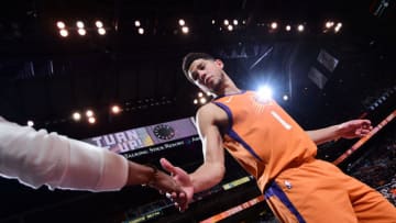 PHOENIX, AZ - JANUARY 31: Devin Booker #1 of the Phoenix Suns high fives a fan during the game against the Oklahoma City Thunder on January 31, 2020 at Talking Stick Resort Arena in Phoenix, Arizona. NOTE TO USER: User expressly acknowledges and agrees that, by downloading and or using this photograph, user is consenting to the terms and conditions of the Getty Images License Agreement. Mandatory Copyright Notice: Copyright 2020 NBAE (Photo by Michael Gonzales/NBAE via Getty Images)