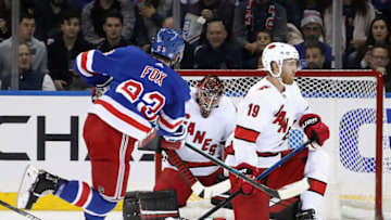 NEW YORK, NEW YORK - NOVEMBER 27: Petr Mrazek #34 and Dougie Hamilton #19 of the Carolina Hurricanes looks to block a shot by Adam Fox #23 of the New York Rangers during the first period at Madison Square Garden on November 27, 2019 in New York City. (Photo by Bruce Bennett/Getty Images)
