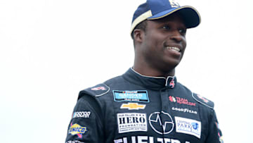 TALLADEGA, ALABAMA - OCTOBER 12: Jesse Iwuji, driver of the #34 John's 360 Coatings Toyota, stands on the grid during qualifying for the NASCAR Gander Outdoor Truck Series Sugarlands Shine 250 at Talladega Superspeedway on October 12, 2019 in Talladega, Alabama. (Photo by Jared C. Tilton/Getty Images)