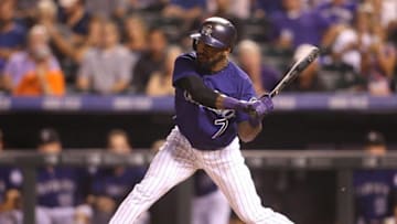 Sep 2, 2015; Denver, CO, USA; Colorado Rockies shortstop Jose Reyes (7) hits a single during the fifth inning against the Arizona Diamondbacks at Coors Field. Mandatory Credit: Chris Humphreys-USA TODAY Sports