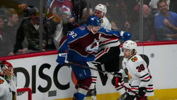 Oct 13, 2021; Denver, Colorado, USA; Colorado Avalanche left wing Gabriel Landeskog (92) checks Chicago Blackhawks defenseman Calvin de Haan (44) in the third period at Ball Arena. Mandatory Credit: Ron Chenoy-USA TODAY Sports