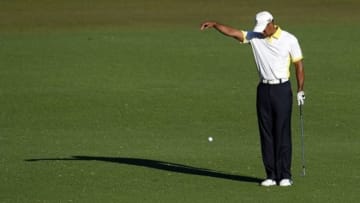 Apr 12, 2013; Augusta, GA, USA; Tiger Woods takes a drop on the 15th hole during the second round of the 2013 The Masters golf tournament at Augusta National Golf Club. Mandatory Credit: Michael Madrid-USA TODAY Sports