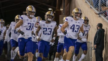 Oct 30, 2021; Stanford, California, USA; Washington Huskies players run out onto the field before a game against the Stanford Cardinal at Stanford Stadium. Mandatory Credit: Neville E. Guard-USA TODAY Sports