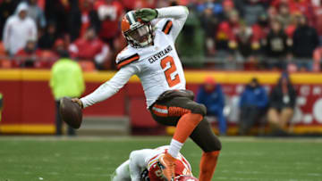 KANSAS CITY, MO - DECEMBER 27: Johnny Manziel #2 of the Cleveland Browns fights his way out of a tackle attempt from Derrick Johnson #56 of the Kansas City Chiefs at Arrowhead Stadium during the fourth quarter of the game on December 27, 2015 in Kansas City, Missouri. (Photo by Peter Aiken/Getty Images)