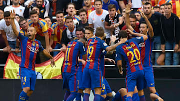 VALENCIA, SPAIN - OCTOBER 22: Barcelona are hit by objects thrown from the seats after Lionel Messi of FC Barcelona scores his team's third goal from the penalty spot during the La Liga match between Valencia CF and FC Barcelona at Mestalla Stadium on October 22, 2016 in Valencia, Spain. (Photo by Manuel Queimadelos Alonso/Getty Images)