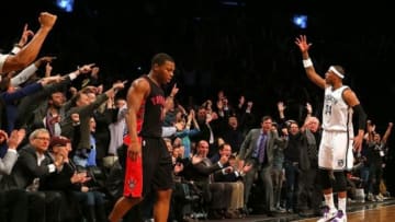Mar 10, 2014; Brooklyn, NY, USA; Brooklyn Nets small forward Paul Pierce (34) reacts after hitting a three-point shot in front of Toronto Raptors point guard Kyle Lowry (7) late in the fourth quarter at the Barclays Center. The Brooklyn Nets defeated the Toronto Raptors 101-97. Mandatory Credit: Adam Hunger-USA TODAY Sports