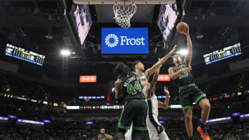 Jan 7, 2023; San Antonio, Texas, USA; Boston Celtics guard Malcolm Brogdon (13) shoots the ball over San Antonio Spurs forwards Zach Collins (23) and guard Josh Richardson (7) during the second half at AT&T Center. Mandatory Credit: Scott Wachter-USA TODAY Sports