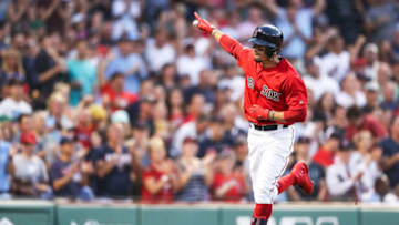 BOSTON, MA - JULY 26: Mookie Betts #50 of the Boston Red Sox reacts as he returns to the dugout after hitting a solo home run in the third inning of a game against the New York Yankees at Fenway Park on July 26, 2019 in Boston, Massachusetts. (Photo by Adam Glanzman/Getty Images)