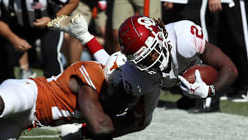 DALLAS, TEXAS - OCTOBER 12: CeeDee Lamb #2 of the Oklahoma Sooners is tackled by Chris Brown #15 of the Texas Longhorns in the first quarter during the 2019 AT&T Red River Showdown at Cotton Bowl on October 12, 2019 in Dallas, Texas. (Photo by Ronald Martinez/Getty Images)