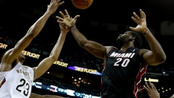 Oct 23, 2013; New Orleans, LA, USA; Miami Heat center Greg Oden (20) and New Orleans Pelicans power forward Anthony Davis (23) battle for a rebound during the first half of a preseason game at New Orleans Arena. Mandatory Credit: Derick E. Hingle-USA TODAY Sports
