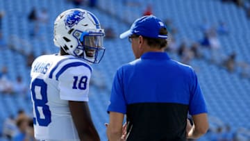CHAPEL HILL, NORTH CAROLINA - OCTOBER 26: Quentin Harris #18 of the Duke Blue Devils talks to his head coach, David Cutcliffe, as he warms up before their game against the North Carolina Tar Heels during their game at Kenan Stadium on October 26, 2019 in Chapel Hill, North Carolina. (Photo by Streeter Lecka/Getty Images)