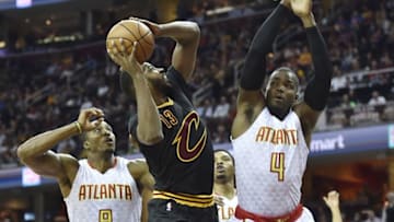 Nov 8, 2016; Cleveland, OH, USA; Cleveland Cavaliers center Tristan Thompson (13) shoots the ball between Atlanta Hawks center Dwight Howard (8) and forward Paul Millsap (4) in the first quarter at Quicken Loans Arena. Mandatory Credit: David Richard-USA TODAY Sports