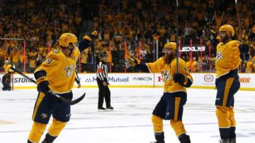NASHVILLE, TENNESSEE - APRIL 10: Ryan Ellis #4 and Austin Watson #51 of the Nashville Predators react after a goal by teammate Roman Josi #59 against the Dallas Stars in Game One of the Western Conference First Round during the 2019 NHL Stanley Cup Playoffs at Bridgestone Arena on April 10, 2019 in Nashville, Tennessee. (Photo by Frederick Breedon/Getty Images)