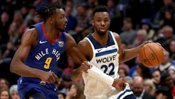 Andrew Wiggins of the Minnesota Timberwolves drives against Jerami Grant of the Denver Nuggets. (Photo by Matthew Stockman/Getty Images)