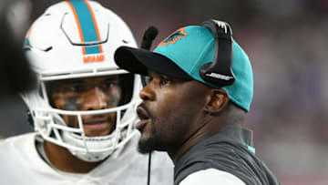 Sep 12, 2021; Foxborough, Massachusetts, USA; Miami Dolphins head coach Brian Flores talks with quarterback Tua Tagovailoa (1) during a timeout during the second half of a game against the New England Patriots at Gillette Stadium. Mandatory Credit: Brian Fluharty-USA TODAY Sports