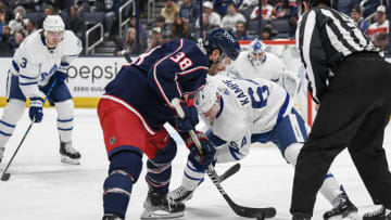 Mar 7, 2022; Columbus, Ohio, USA; Columbus Blue Jackets center Boone Jenner (38) and Toronto Maple Leafs center David Kampf (64) face-off in the first period at Nationwide Arena. Mandatory Credit: Gaelen Morse-USA TODAY Sports