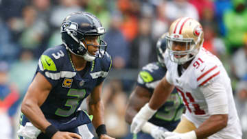 SEATTLE, WA - SEPTEMBER 17: Quarterback Russell Wilson #3 of the Seattle Seahawks runs downfield against defensive lineman Arik Armstead of the San Francisco 49ers during the second half of the game at CenturyLink Field on September 17, 2017 in Seattle, Washington. The Seattle Seahawks beat the San Francisco 49ers 12-9. (Photo by Otto Greule Jr/Getty Images)