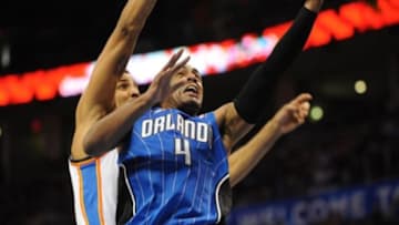 Dec 15, 2013; Oklahoma City, OK, USA; Orlando Magic shooting guard Arron Afflalo (4) attempts a shot while being defended by Oklahoma City Thunder shooting guard Thabo Sefolosha (25) during the second quarter at Chesapeake Energy Arena. Mandatory Credit: Mark D. Smith-USA TODAY Sports