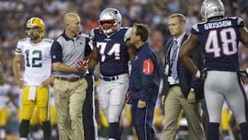 Aug 13, 2015; Foxborough, MA, USA; New England Patriots defensive end Trey Flowers (74) is helped off the field against the Green Bay Packers during the first half in a preseason NFL football game at Gillette Stadium. Mandatory Credit: David Butler II-USA TODAY Sports