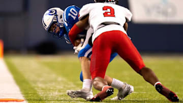 Cleveland Glenville defensive back Bryce West (2) tackles Wyoming Cowboys wide receiver Will Svendsen (10) causing a turnover on downs in the third quarter of the OHSAA DIV state championship game between at Tom Benson Hall of Fame Stadium in Canton, Ohio, on Saturday, Dec. 3, 2022.High School Football Wyoming Vs Cleveland Glenville In Ohsaa Div State Championship Game