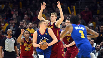 CLEVELAND, OHIO - MARCH 18: Nikola Jokic #15 of the Denver Nuggets looks for a pass while under pressure from Lauri Markkanen #24 of the Cleveland Cavaliers during the fourth quarter at Rocket Mortgage Fieldhouse on March 18, 2022 in Cleveland, Ohio. NOTE TO USER: User expressly acknowledges and agrees that, by downloading and/or using this photograph, user is consenting to the terms and conditions of the Getty Images License Agreement. (Photo by Jason Miller/Getty Images)