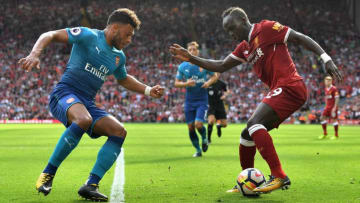 LIVERPOOL, ENGLAND - AUGUST 27: Sadio Mane of Liverpool and Alex Oxlade-Chamberlain of Arsenal battle for possession during the Premier League match between Liverpool and Arsenal at Anfield on August 27, 2017 in Liverpool, England. (Photo by Michael Regan/Getty Images)