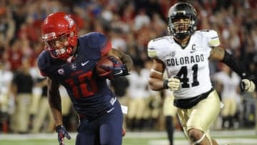 Nov 8, 2014; Tucson, AZ, USA; Arizona Wildcats running back Samajie Grant (10) runs the ball for a touchdown as he is pursued by Colorado Buffaloes defensive back Terrel Smith (41) during the second half at Arizona Stadium. Arizona won 38-20. Mandatory Credit: Casey Sapio-USA TODAY Sports