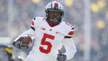 Nov 30, 2013; Ann Arbor, MI, USA; Ohio State Buckeyes quarterback Braxton Miller (5) runs the ball for a touchdown in the second quarter against the Michigan Wolverines at Michigan Stadium. Mandatory Credit: Rick Osentoski-USA TODAY Sports