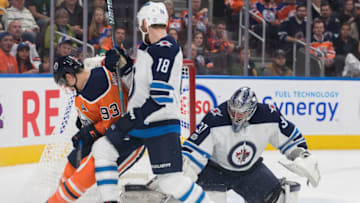 EDMONTON, AB - OCTOBER 09: Winnipeg Jets Goalie Connor Hellebuyck (37) makes a save on Edmonton Oilers Center Ryan Nugent-Hopkins (93) while Winnipeg Jets Center Bryan Little (18) ties him up during the Edmonton Oilers game versus the Winnipeg Jets at Rogers Place in Edmonton, AB (Photo by Curtis Comeau/Icon Sportswire via Getty Images)
